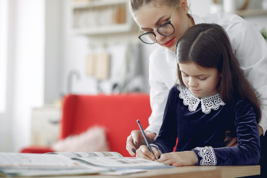 focused young woman and girl drawing together at home 4173332 1